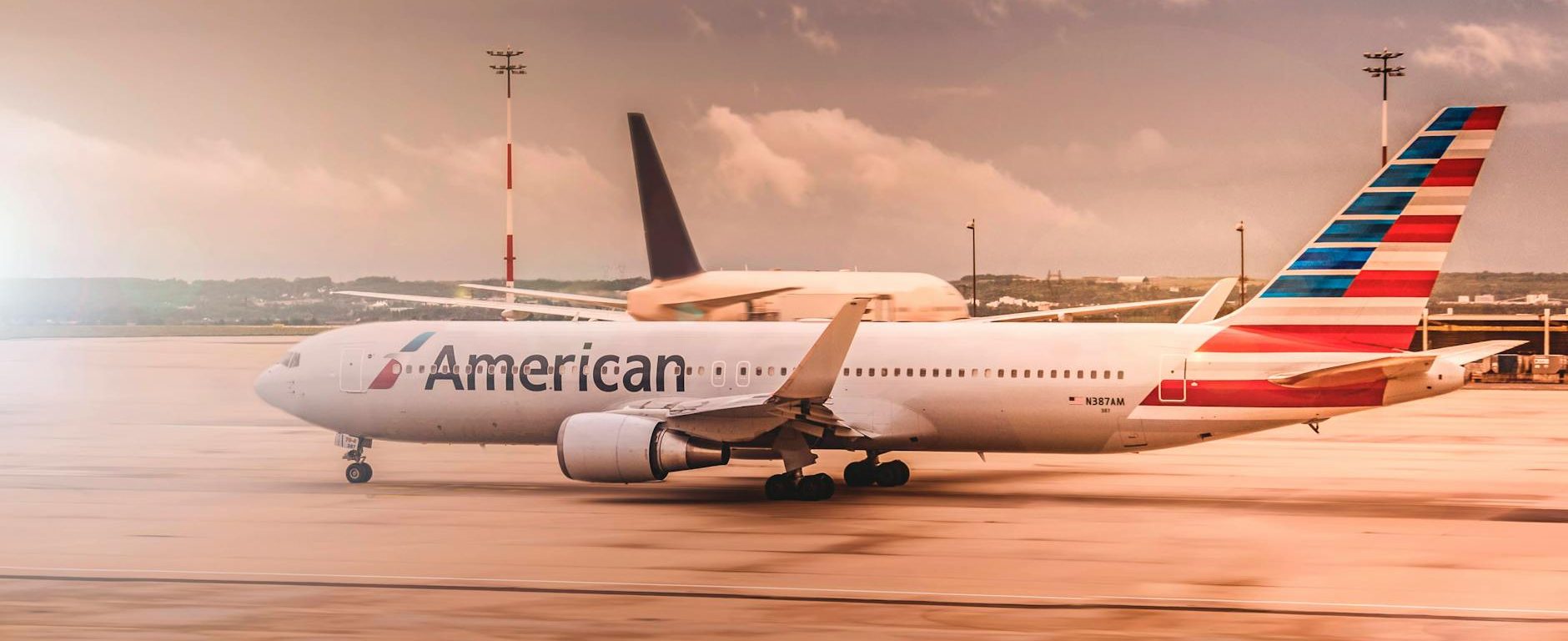 white american airplane parked on airport